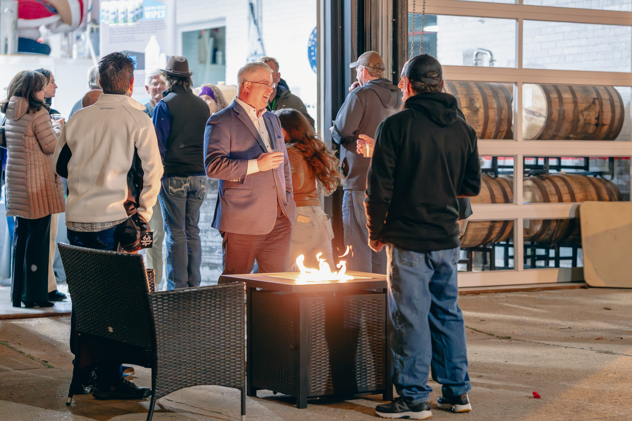 Guests gathering around a fire table at Brady's Distillery